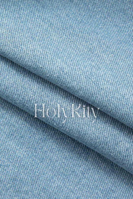 Gilet court en jean asymétrique à poches à rabat et boutons